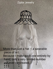 Load image into Gallery viewer, Black avant-garde sculptural hat made from zip ties worn by a mannequin.
