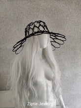 Load image into Gallery viewer, Black avant-garde sculptural hat made from zip ties worn by a mannequin.
